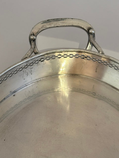 Detail of the oval tray's twin loop handle and pierced gallery rim