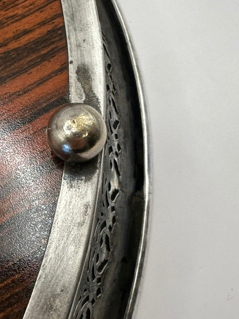 Close-up of the tray's pierced silver-plate gallery rim and rounded ball foot