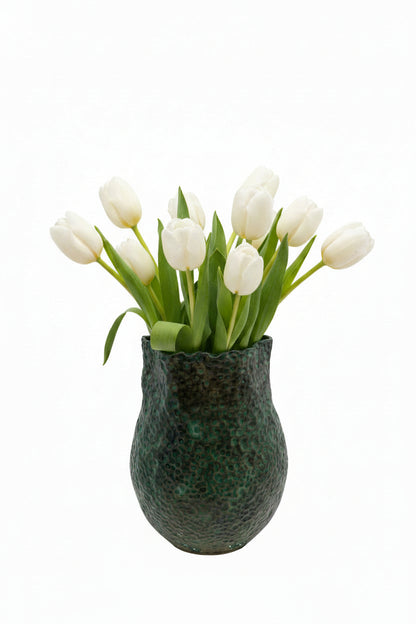 The tall green stoneware vessel styled with a bouquet of white tulips
