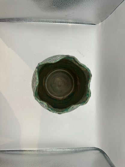 Top-down view into the tall stoneware vessel showing the wheel-thrown interior