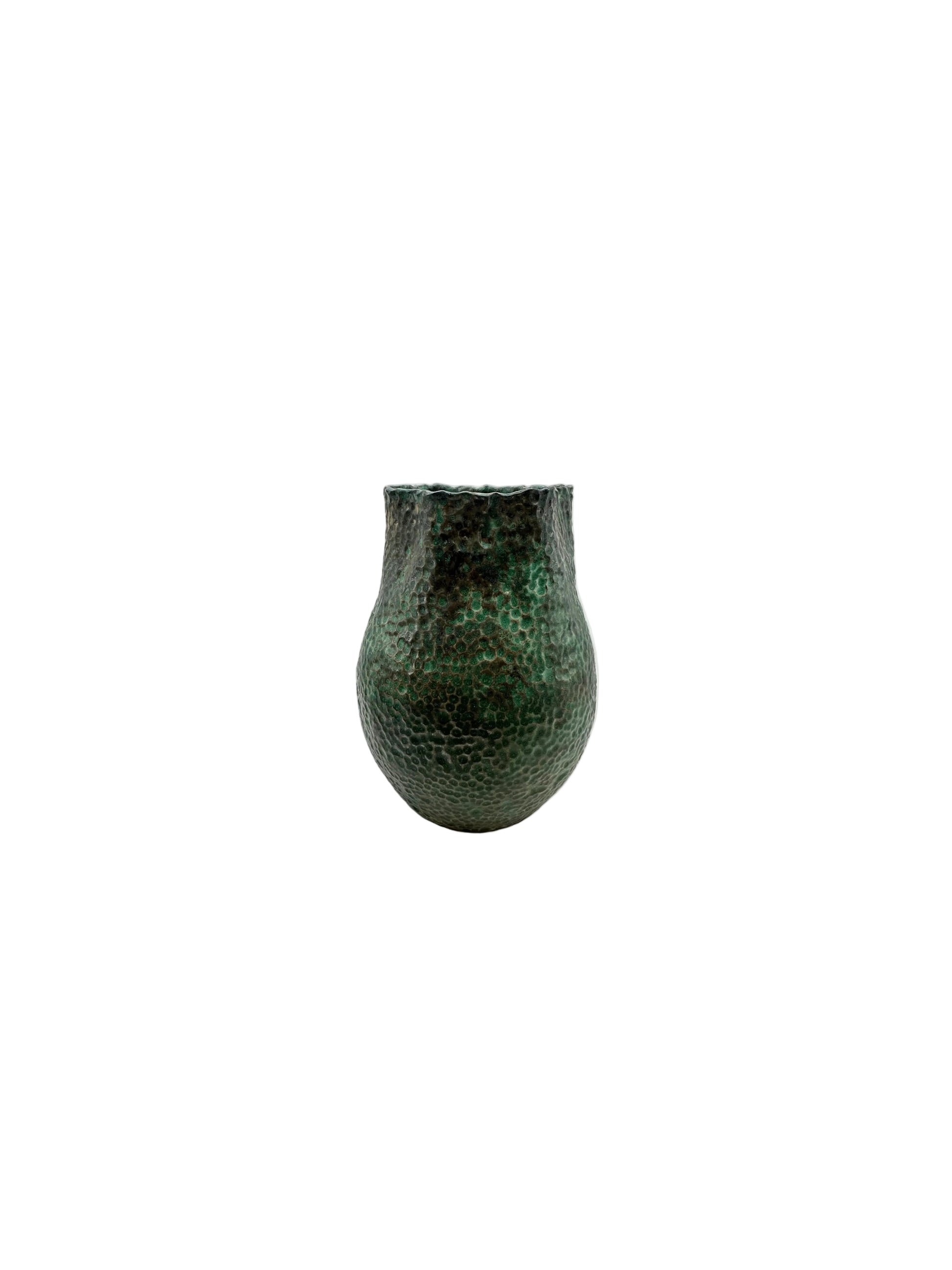 Tall green stoneware vessel showing mottled verdigris glaze and a ruffled rim