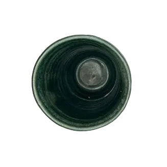 Close-up of the green stoneware vessel rim showing satin glaze and surface variation