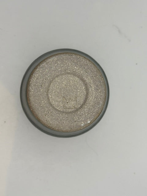 Studio-made green satin-glazed stoneware vessel, angled top view on white background