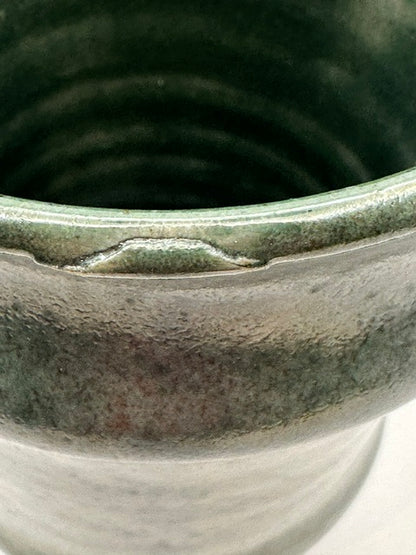 Green satin-glazed stoneware vessel, front view on white background