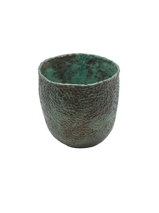 Wide-mouth green stoneware vessel with dimpled exterior and bright green glazed interior, front view