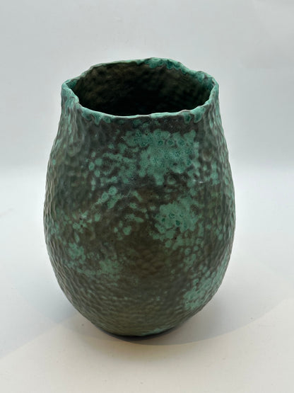 Front view of the medium green stoneware vessel showing its mottled verdigris glaze