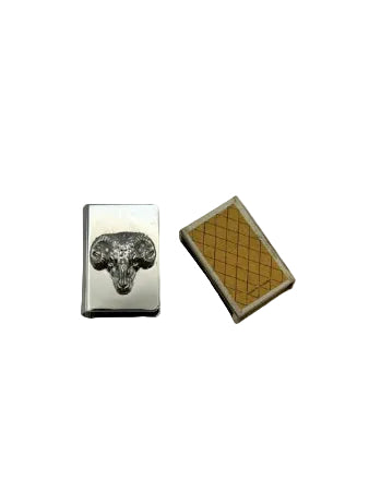 Silver-plate ram's head matchbox cover beside the gold matchbox it sheathes, top view