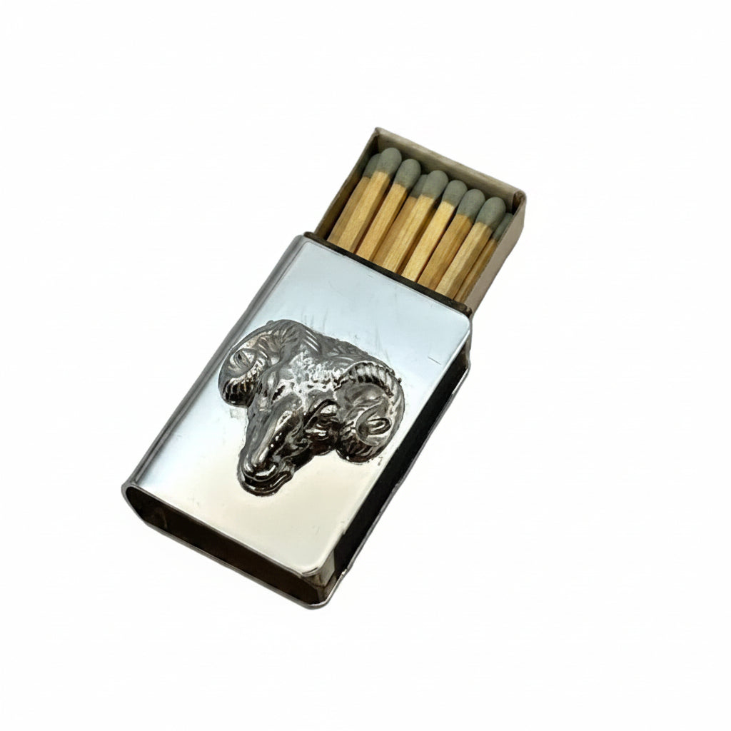Silver-plate ram's head matchbox cover slid over an open box of matches, angled