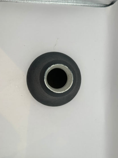 Overhead view of black stoneware vase opening with pale unglazed rim.