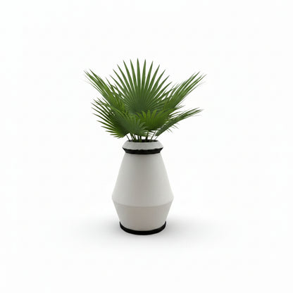 Studio-made white stoneware vessel styled with a green fan-palm arrangement.