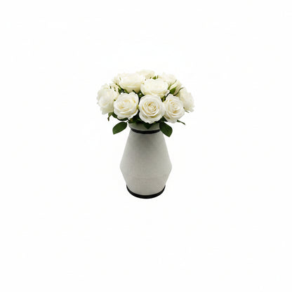Studio-made white stoneware vessel styled with a bouquet of white roses.
