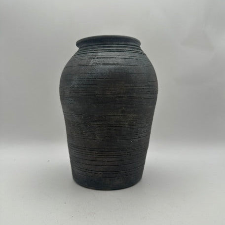 Black ribbed ginger-jar ceramic vase on gray backdrop, front view