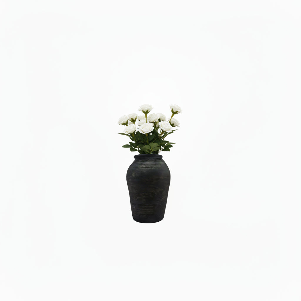 Black matte ribbed ginger-jar ceramic vase holding white roses, front view