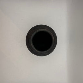 Close-up of the black ribbed vase's circular mouth and opening, top-down view