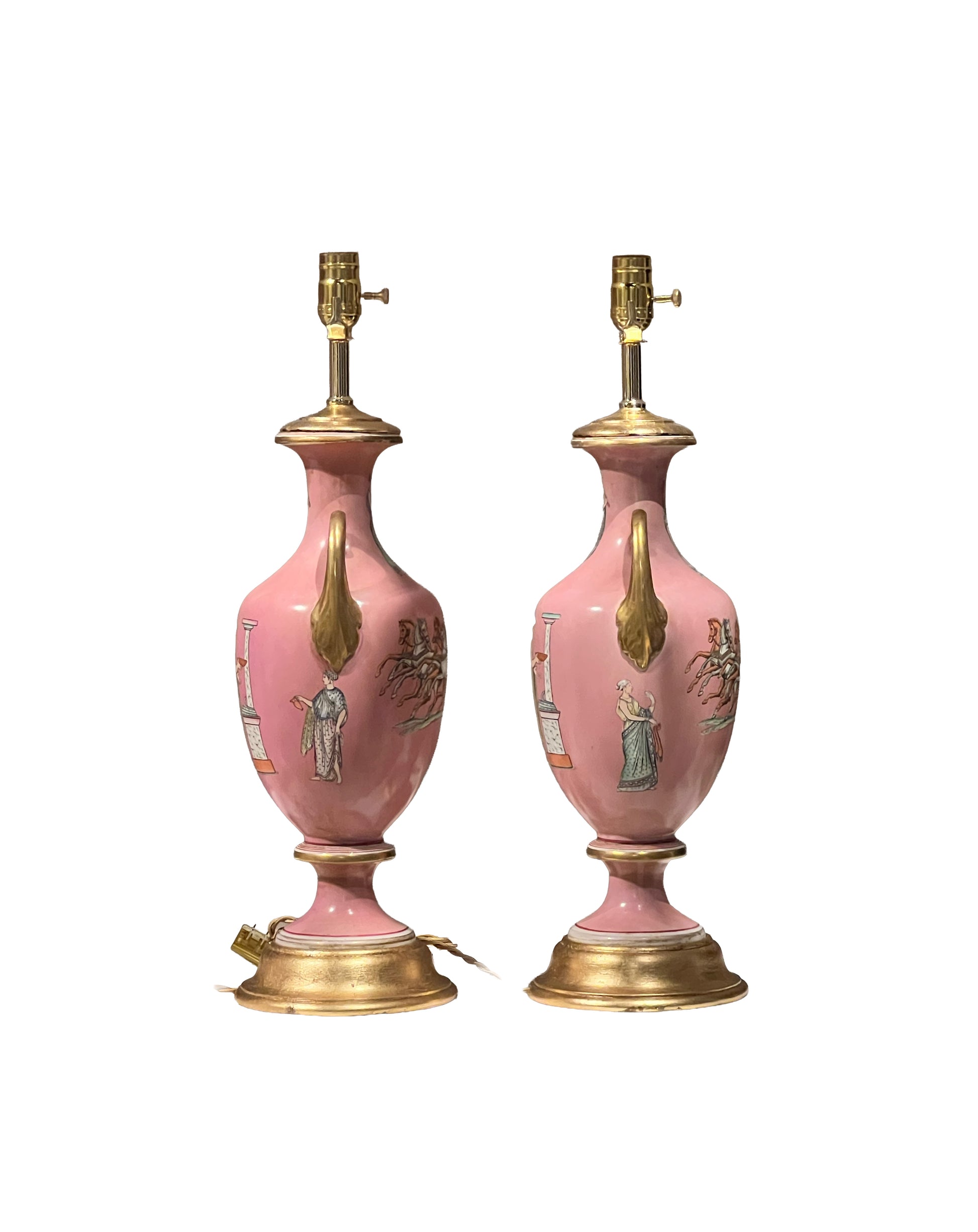 Side view of the pink urn lamp pair showing painted classical figures and gilt turned bases