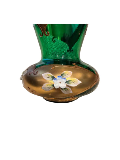 Close-up of the vase's bulbous base showing a raised white and blue enamel flower on a gold band