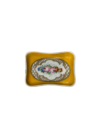 Vintage French trinket dish, yellow porcelain with hand-painted roses in a gilt oval, angled top view