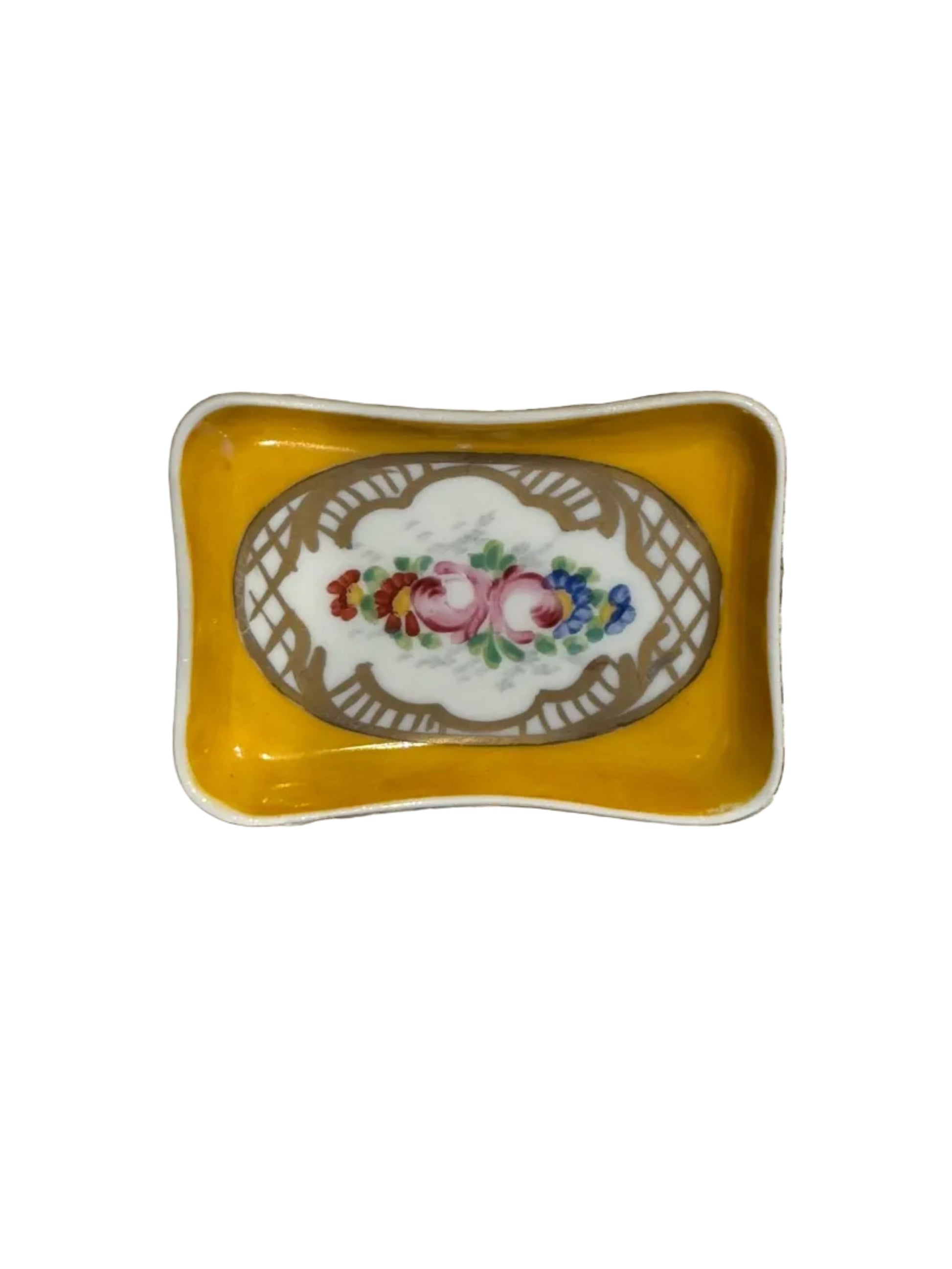 Vintage French hand-painted trinket dish, golden-yellow porcelain with floral spray in gilt lattice frame, top view