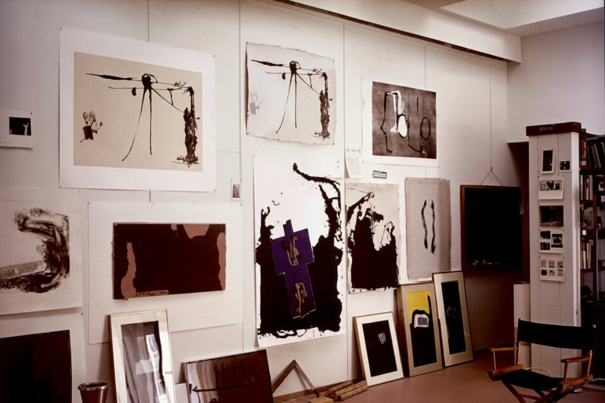 Robert Motherwell print book, photo of a studio wall displaying framed and pinned prints with a director's chair