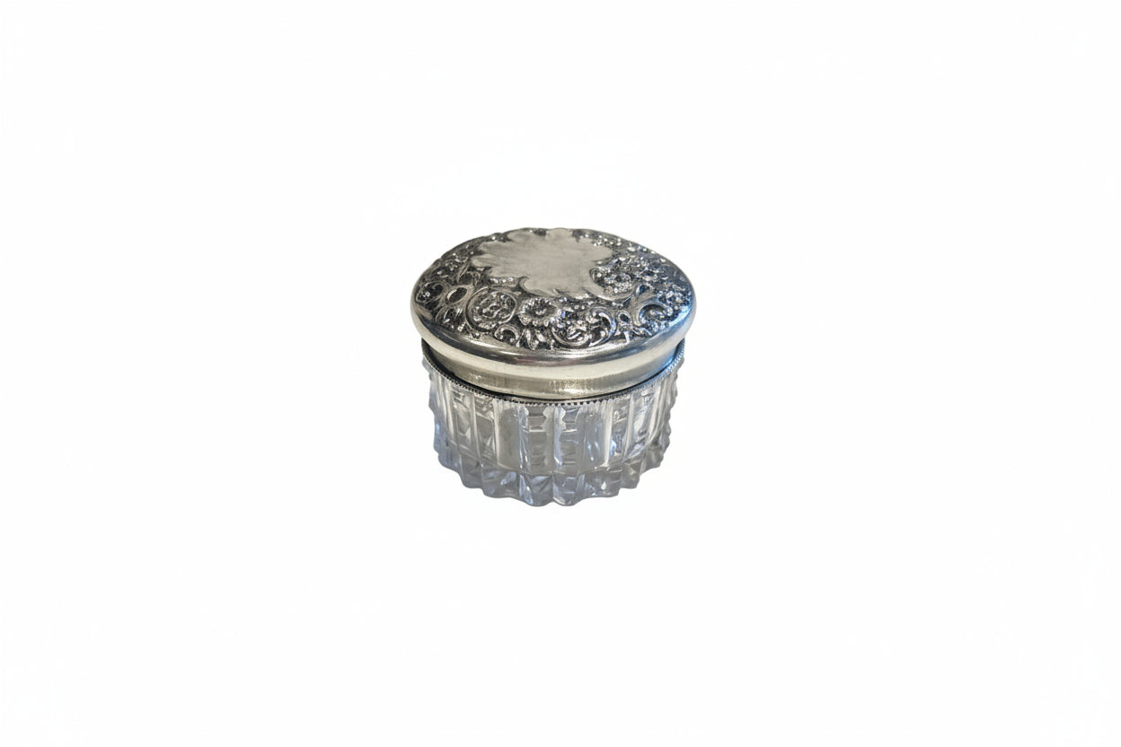 Vintage crystal and sterling petite dresser jar, closed with floral repoussé silver lid and fluted glass body.