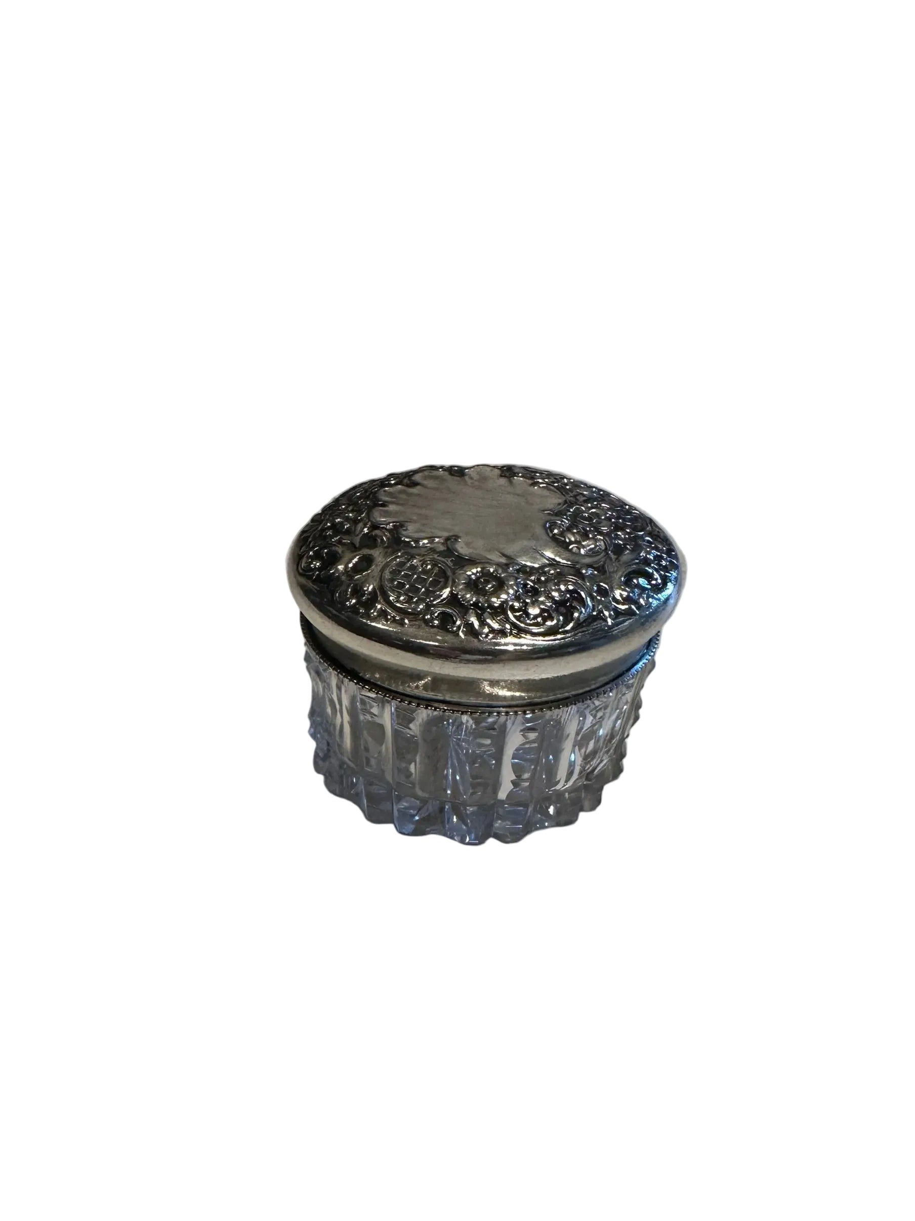 Vintage crystal and sterling petite dresser jar, closed view of the ornate floral repoussé silver lid.