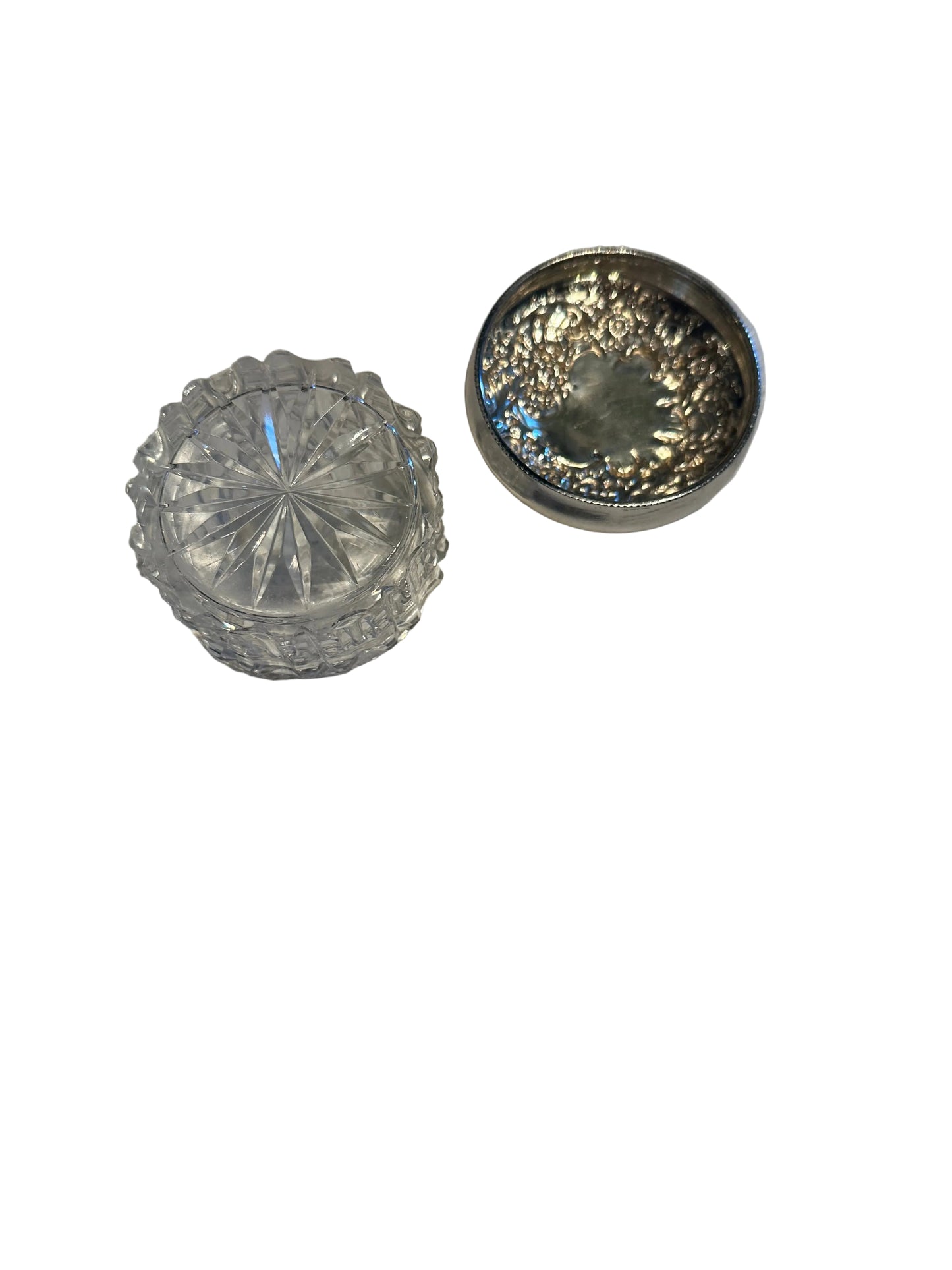 Vintage crystal and sterling petite dresser jar, open jar and floral repoussé lid in three-quarter view.