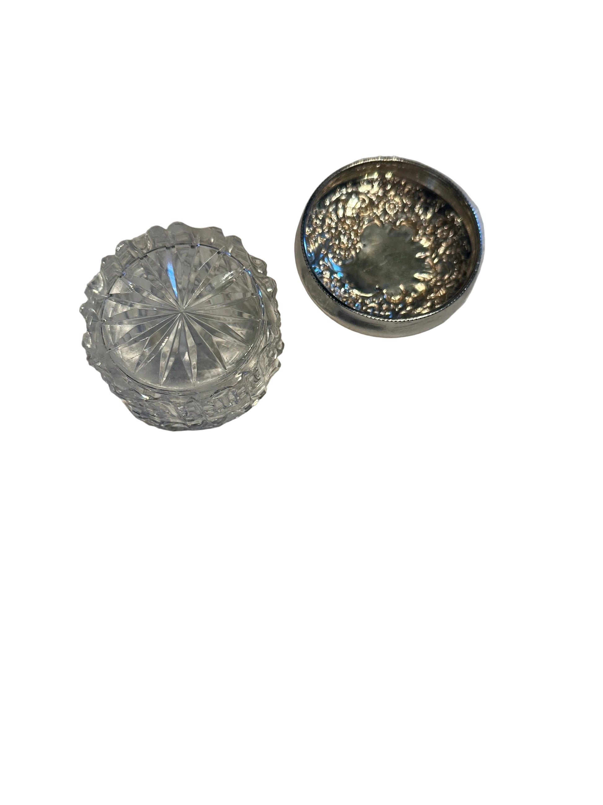 Vintage crystal and sterling petite dresser jar, open jar and floral repoussé lid in three-quarter view.