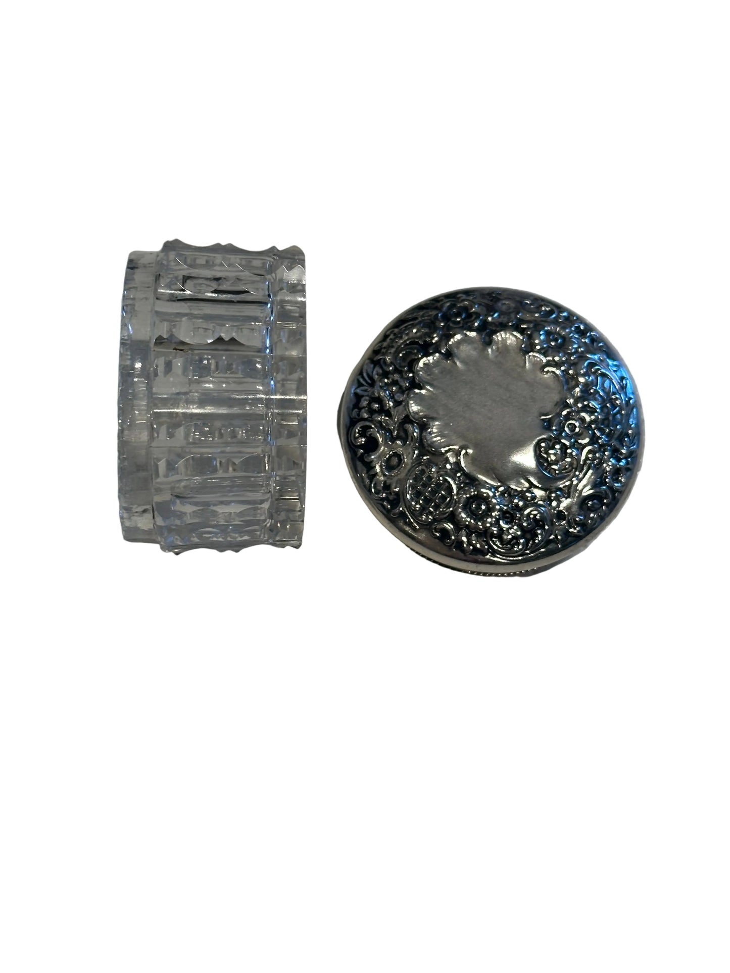 Vintage crystal and sterling petite dresser jar, fluted glass body on its side beside the silver lid.