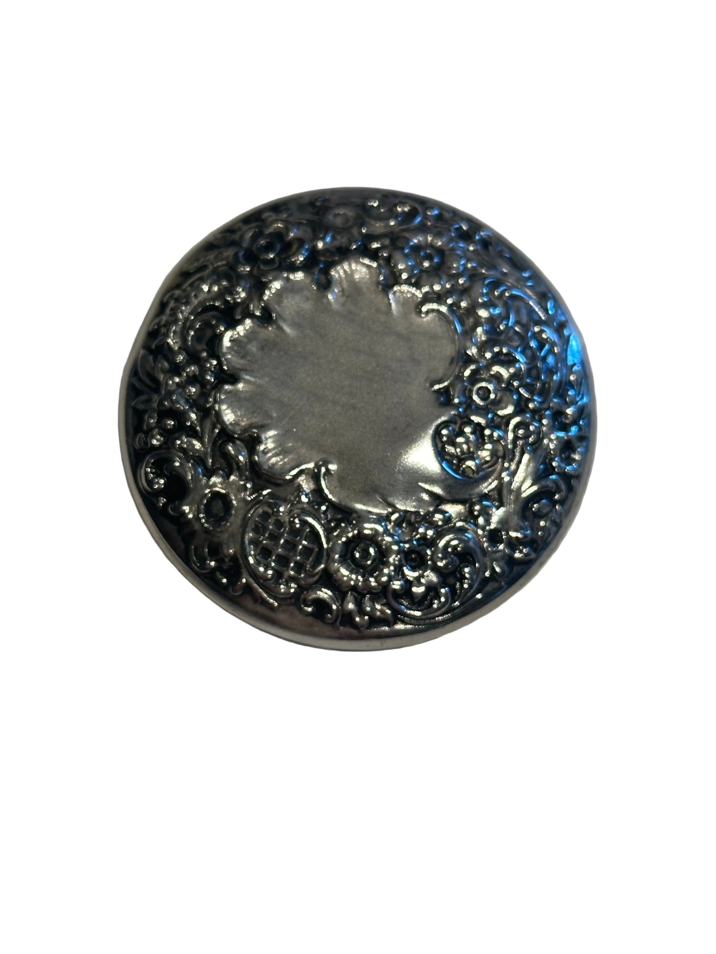 Vintage crystal and sterling petite dresser jar, close-up of the floral repoussé lid with blank cartouche.