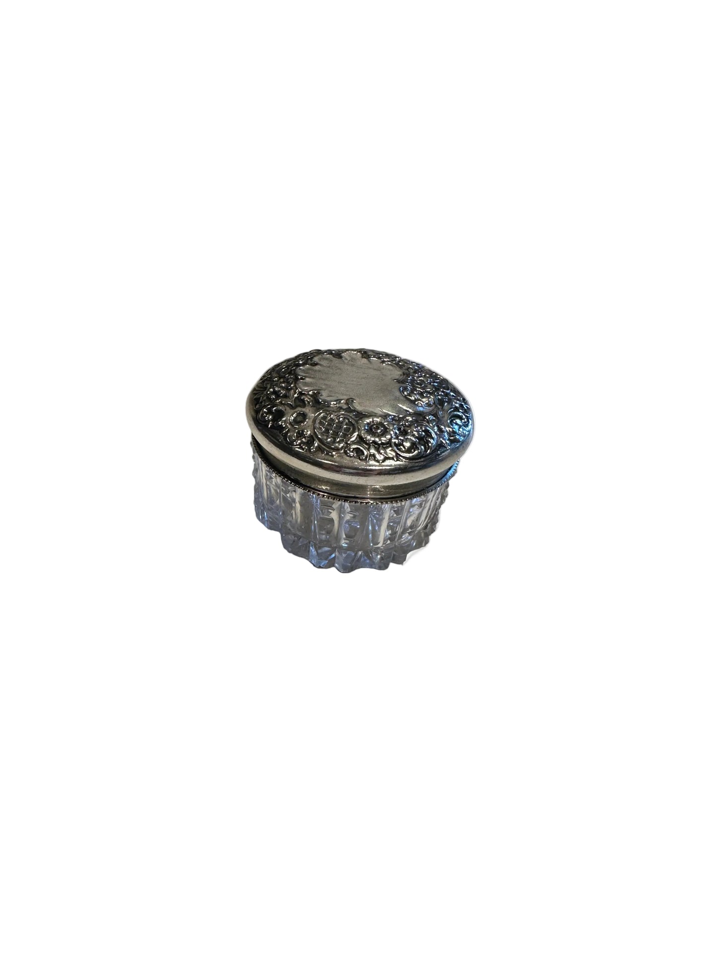 Vintage crystal and sterling petite dresser jar, raised angle showing the floral repoussé silver lid.
