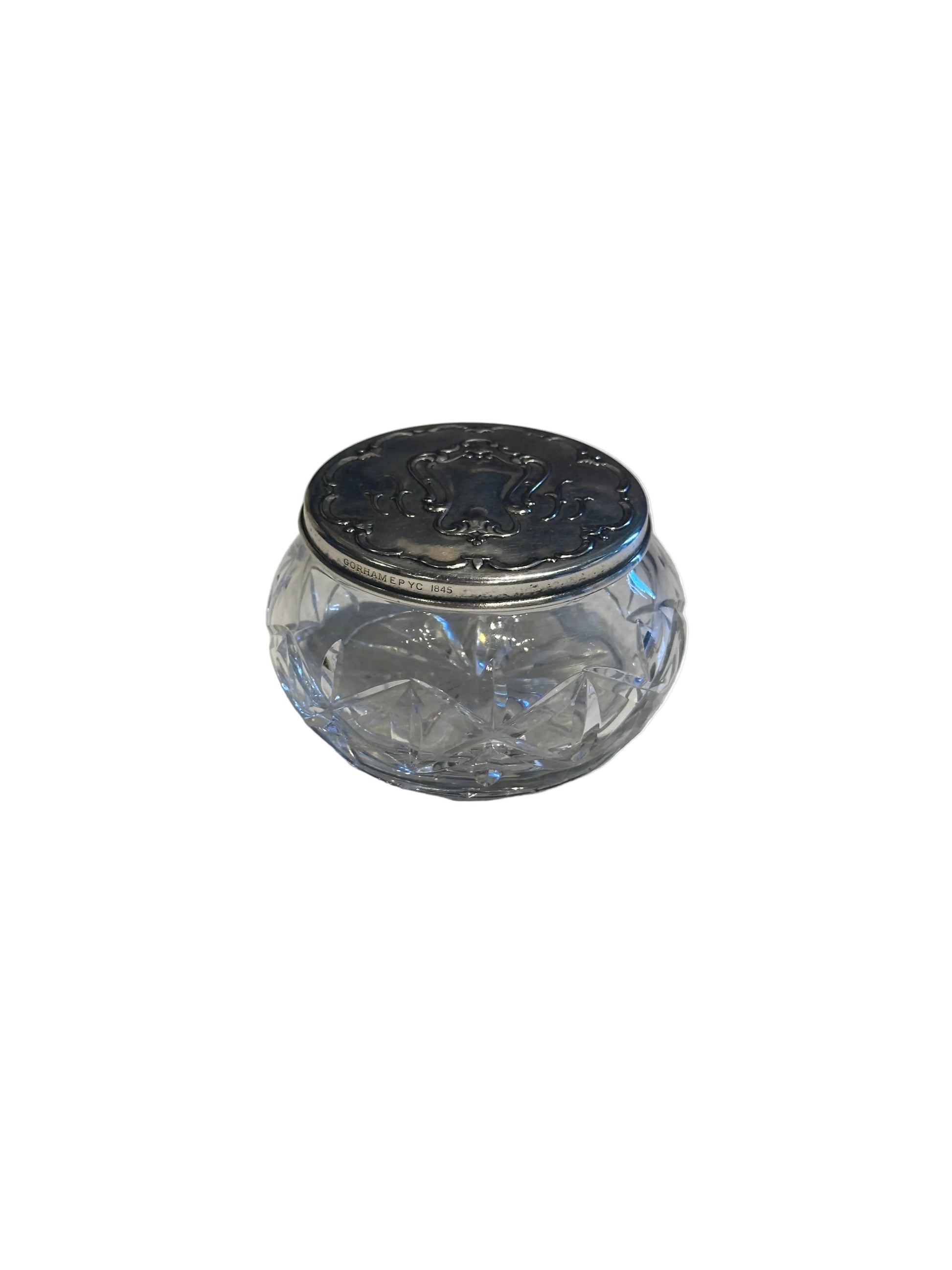 Gorham vintage crystal and silver dresser jar, low angle showing the hallmarked silver collar and lid.