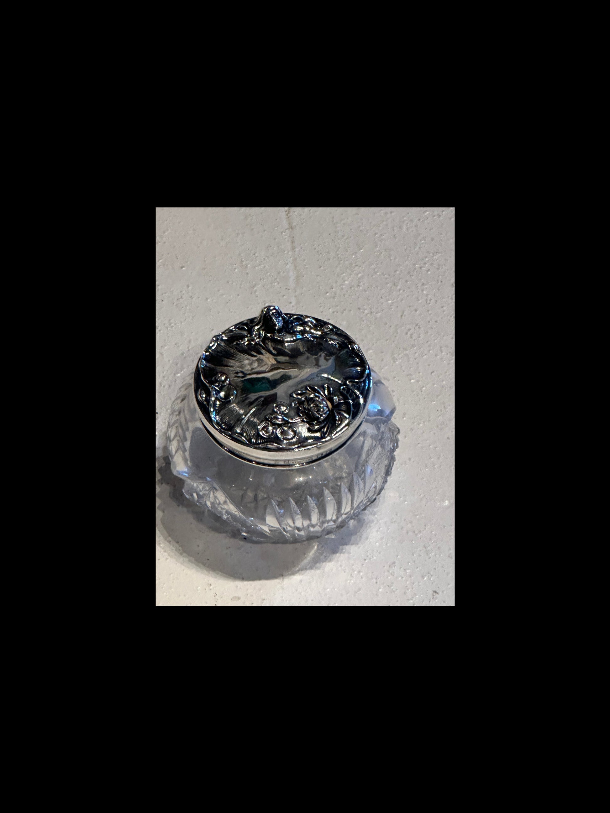 Antique crystal dresser jar, top view of ornate sterling lid with lily pad and floral motifs
