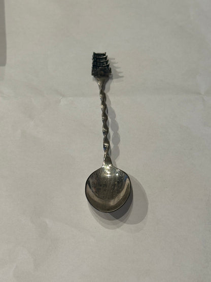 Sterling silver pagoda demitasse spoon, diagonal full view with pagoda finial above the twisted handle.