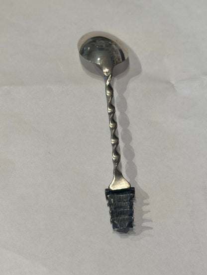 Sterling silver pagoda demitasse spoon, diagonal view showing the twisted handle and pagoda finial detail.
