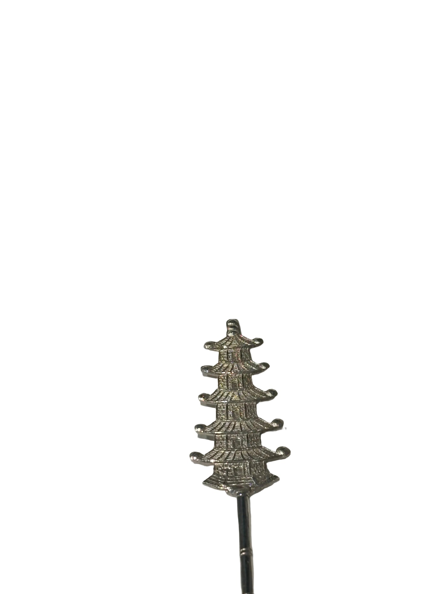 Close-up of the sterling spoon's ornate multi-tiered pagoda finial on bamboo-form stem