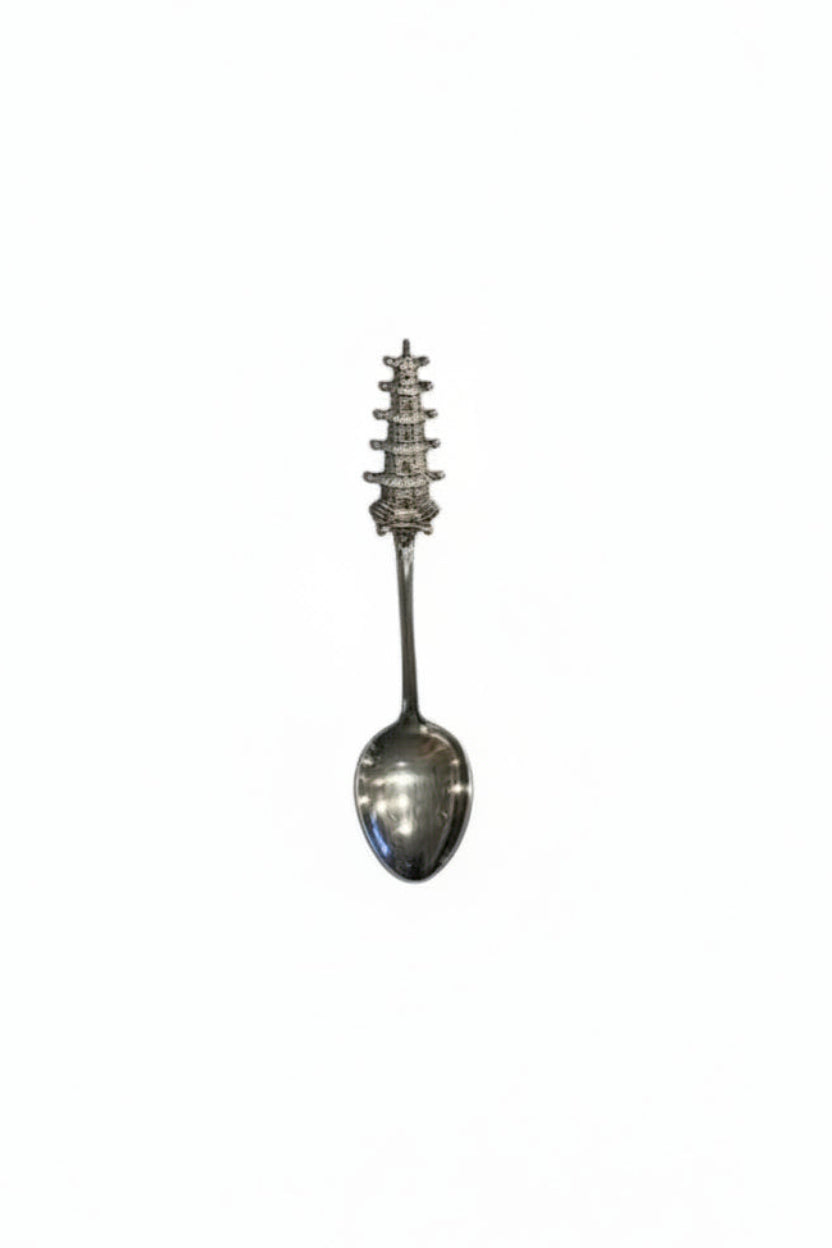 Sterling silver tall pagoda demitasse spoon, full view with multi-tier pagoda finial atop the handle.