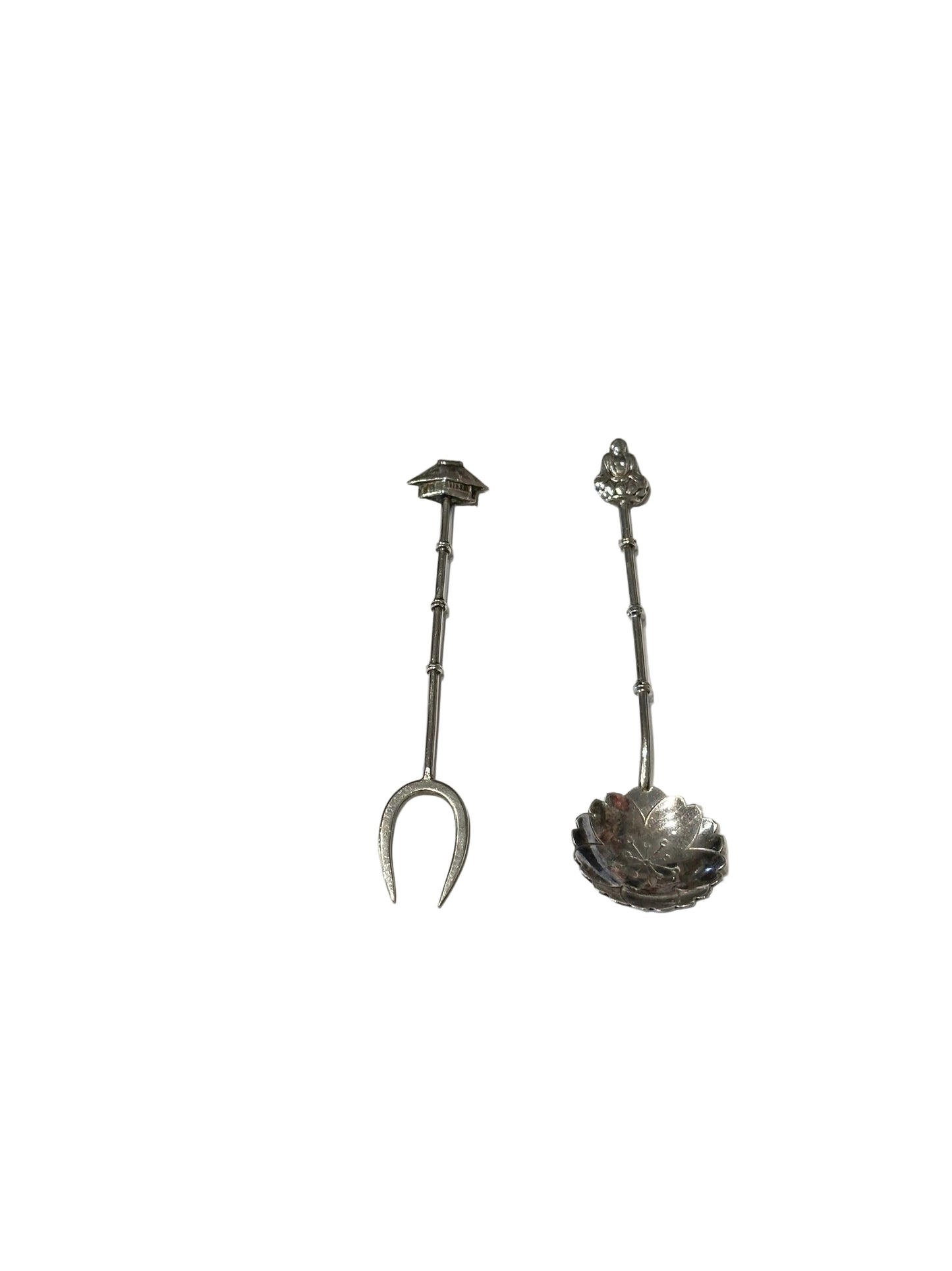 Sterling silver Asian-inspired two-piece fork and floral demitasse spoon set on white