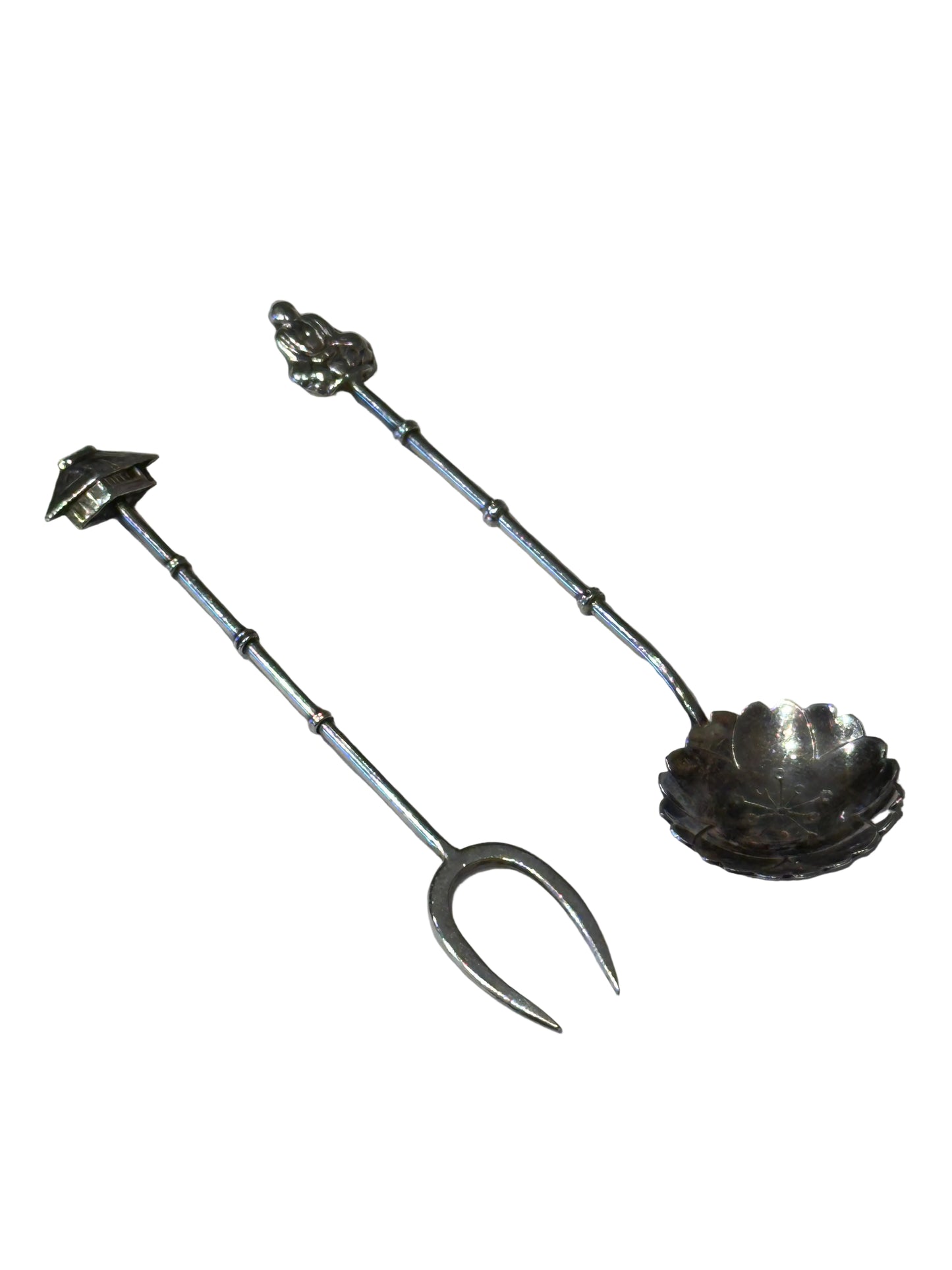 Asian-inspired sterling fork with pagoda finial and spoon with figural finial, diagonal view