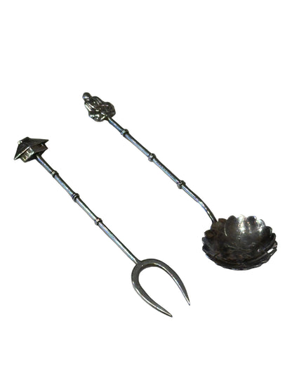 Asian-inspired sterling fork with pagoda finial and spoon with figural finial, diagonal view