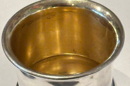 Detail of the toothpick holder's flared rim and gilt interior, side angle
