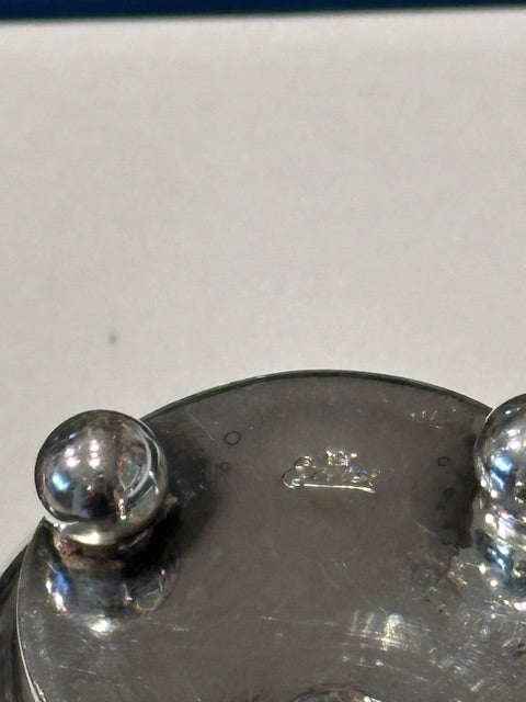Close-up of toothpick holder base showing three ball feet and stamped hallmarks