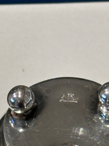 Close-up of toothpick holder base showing three ball feet and stamped hallmarks