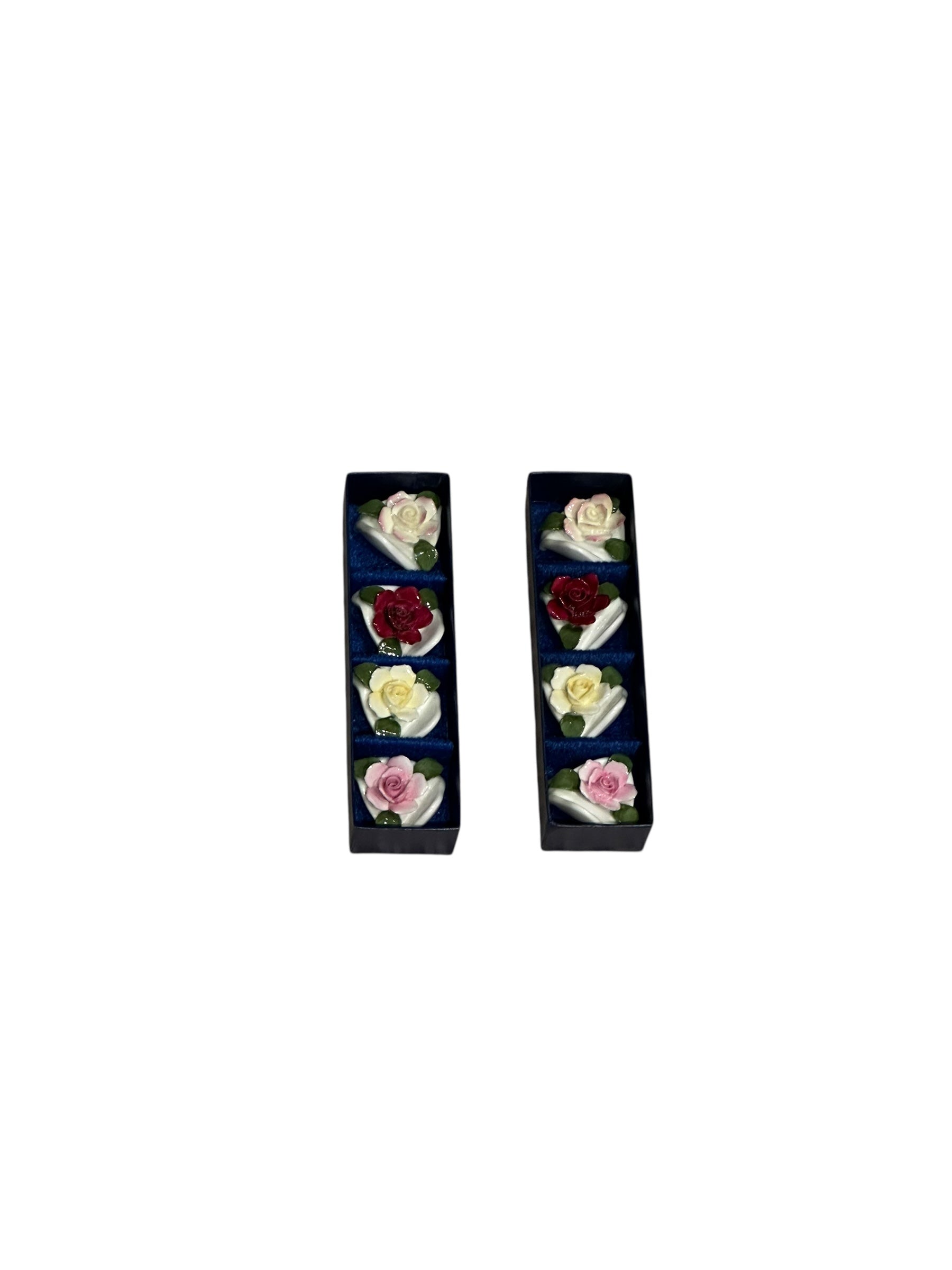 Set of eight porcelain rose place card holders shown in their two original navy boxes
