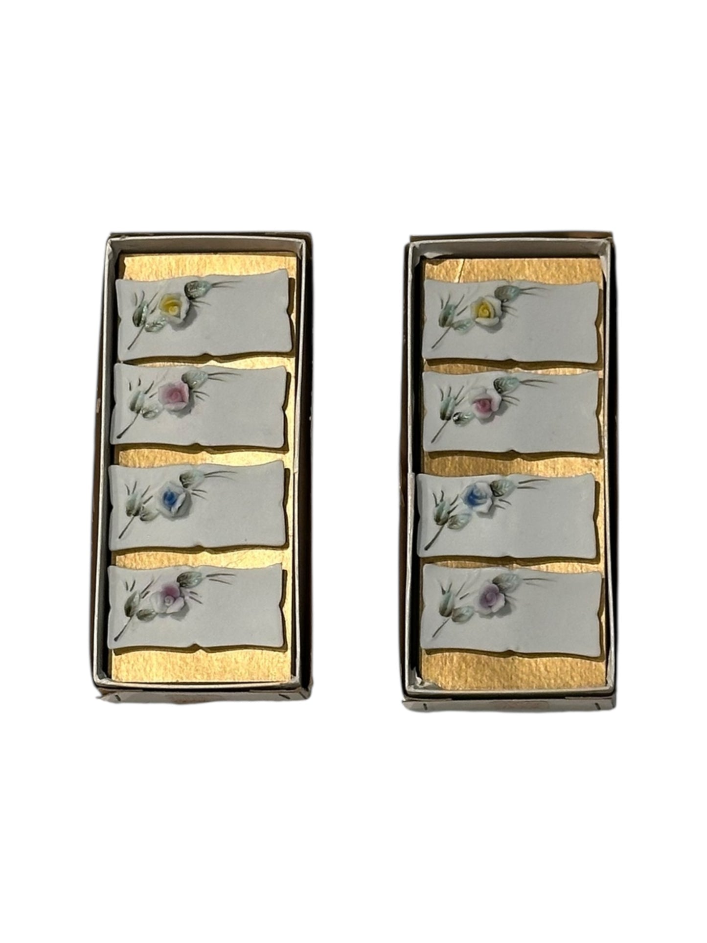 Set of eight floral place card holders shown in their two original gold-lined boxes