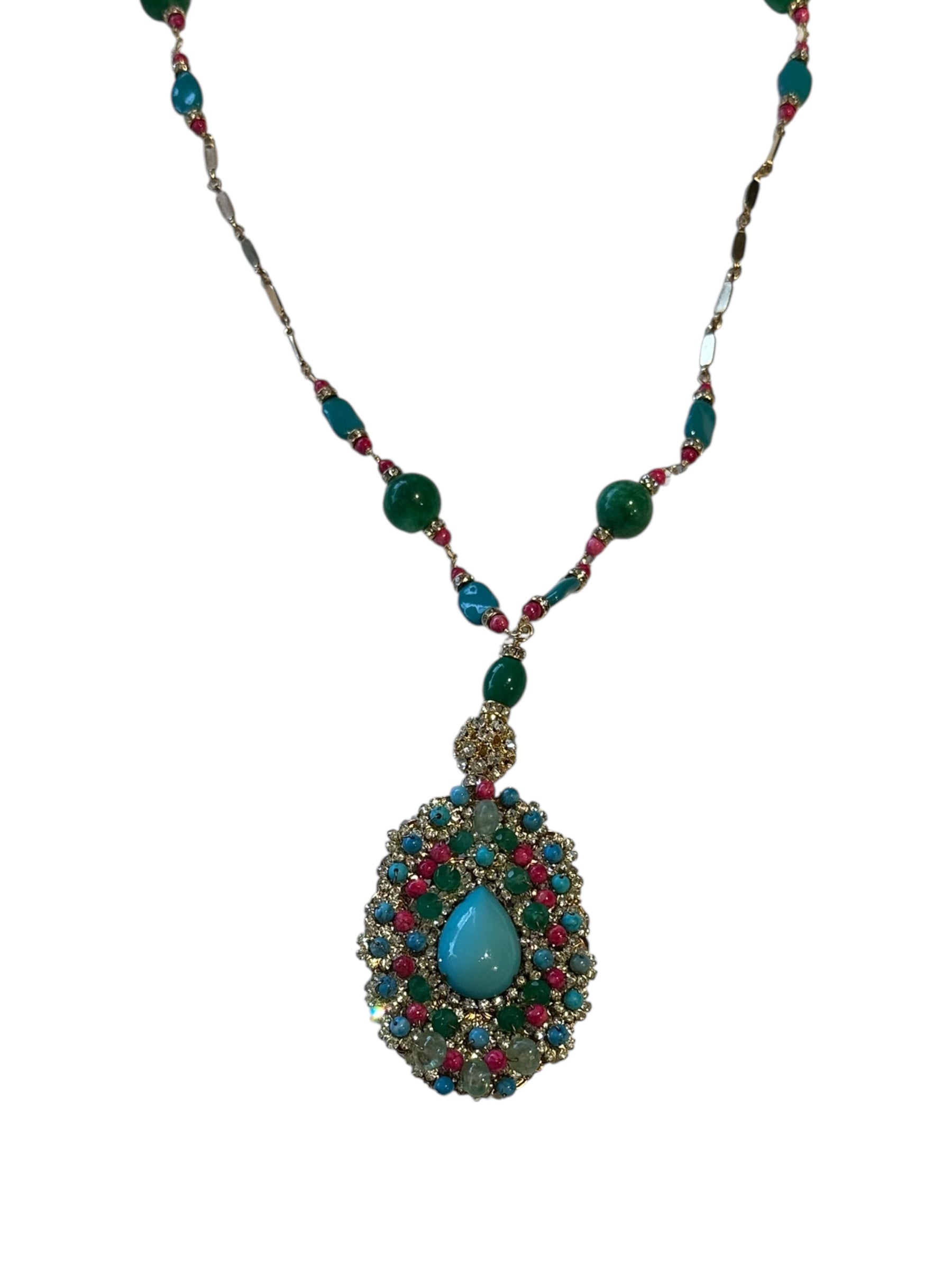 Close-up of the woven pendant with central turquoise teardrop framed by crystals and colored beads