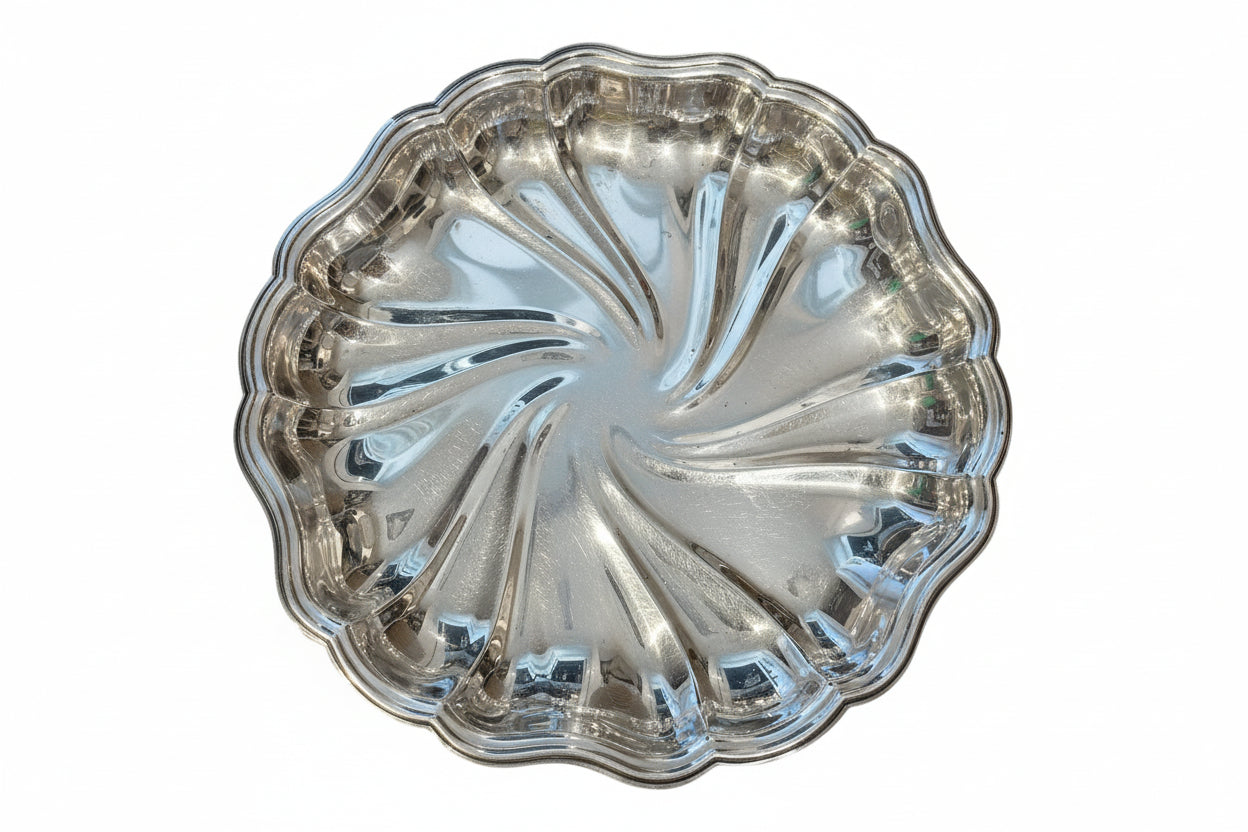 Vintage fluted silverplate serving dish with swirled pinwheel center and scalloped edge, top view