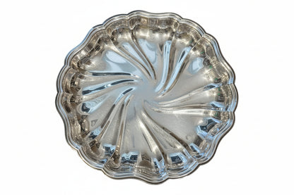 Vintage fluted silverplate serving dish with swirled pinwheel center and scalloped edge, top view