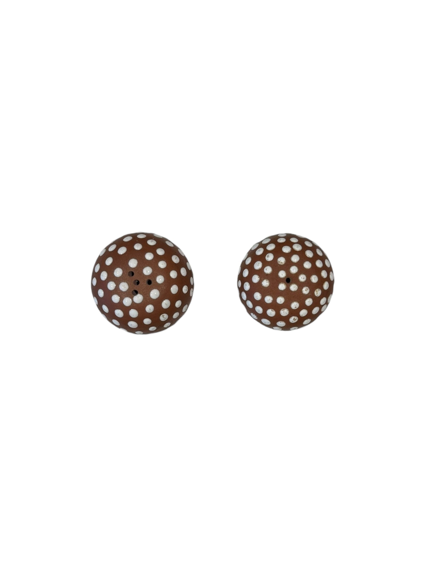 Top view of the pair of brown mushroom salt and pepper shakers with white-dotted caps