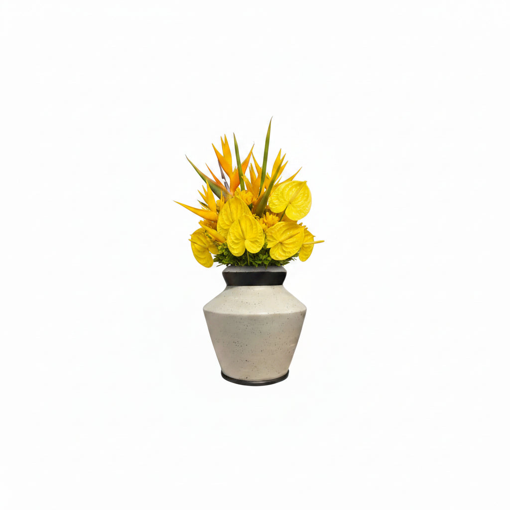 Studio-made white stoneware vessel styled with yellow tropical floral arrangement.