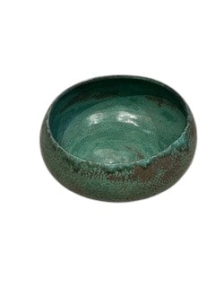 Handmade green glazed stoneware bowl, three-quarter view, glossy teal interior.